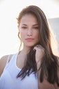 Pretty city girl portrait at sunset backlight at top of building