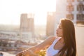 Pretty city girl profile portrait at sunset backlight at top of