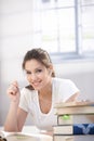 Pretty college student learning at home smiling