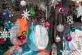 Pretty colorful Christmas ornaments dangling from thread in window of home