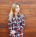 Pretty cool blonde woman in checkered shirt