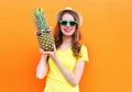 Pretty cool girl in sunglasses with pineapple having fun over colorful Royalty Free Stock Photo