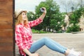 Pretty cool girl taking picture self portrait on smartphone Royalty Free Stock Photo