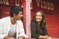 Pretty Couple Flirting and Smiling Each Other Outside of a Red Wooden Saloon