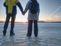 Pretty couple have fun on beach. Winter walk at frozen sea Royalty Free Stock Photo