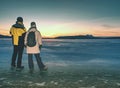 Pretty couple have fun on beach. Winter walk at frozen sea Royalty Free Stock Photo