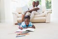 Pretty couple using laptop on couch and their daughter drawing Royalty Free Stock Photo