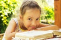 Pretty curly school girl reading an old book outside Royalty Free Stock Photo