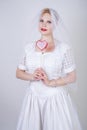 Pretty curvy adult woman with short hair wearing long vintage wedding dress with sun style skirt. young caucasian bride with veil Royalty Free Stock Photo