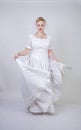 Pretty curvy adult woman with short hair wearing long vintage wedding dress with sun style skirt. young caucasian bride with veil Royalty Free Stock Photo