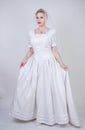 Pretty curvy adult woman with short hair wearing long vintage wedding dress with sun style skirt. young caucasian bride with veil Royalty Free Stock Photo