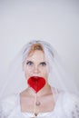 Pretty curvy adult woman with short hair wearing long vintage wedding dress with sun style skirt. young caucasian bride with veil Royalty Free Stock Photo