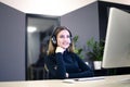 Pretty customer service representative with headphones working in a modern office Royalty Free Stock Photo