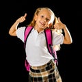 Pretty cute blonde hair girl with a pink schoolbag looking at camera showing thumb up gesture happy to go to school isolated on Royalty Free Stock Photo