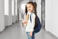 Pretty and cute school girl with funny hairstyle.