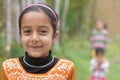 Pretty Cute young Indian girl child smiling with soft green natural backdrop