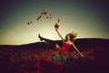 Pretty dancing girl in field of poppy seed