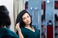 Pretty dark-haired woman admiring her reflection Royalty Free Stock Photo