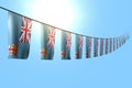 Beautiful many Fiji flags or banners hanging diagonal on string on blue sky background with bokeh - any occasion flag 3d
