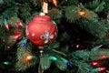 Pretty decoration hanging on lit Christmas tree
