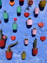 Pretty display of flower pots on wall, Chefchaouen, blue city, Morocco Royalty Free Stock Photo