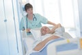 Pretty doctor transporting patient laying on stretcher Royalty Free Stock Photo