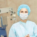 Pretty doctor woman portrait. Ophthalmology laser microscope operation. Clinic room. Patient eye treatment. Myopia and cataract Royalty Free Stock Photo