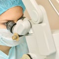 Pretty doctor woman portrait. Ophthalmology laser microscope operation. Clinic room. Patient eye treatment. Myopia and cataract Royalty Free Stock Photo