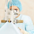 Pretty doctor woman portrait. Ophthalmology laser microscope operation. Clinic room. Patient eye treatment. Myopia and cataract Royalty Free Stock Photo