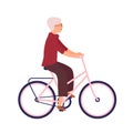 Pretty elderly woman dressed in casual clothes riding bike. Cute smiling old lady on bicycle with her pet animal. Happy