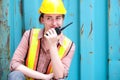 Pretty engineer worker using walkie talkie to control loading containers in the container  area Royalty Free Stock Photo