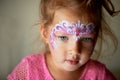 Pretty exciting blue-eyed girl of 2 years with a face painting Royalty Free Stock Photo