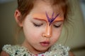 Pretty exciting blue-eyed girl of 2 years with a face painting Royalty Free Stock Photo