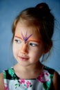 Pretty exciting blue-eyed girl of 2 years with a face painting Royalty Free Stock Photo