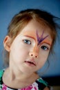 Pretty exciting blue-eyed girl of 2 years with a face painting Royalty Free Stock Photo