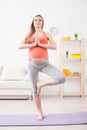 Pretty expectant mother is exercising at home Royalty Free Stock Photo