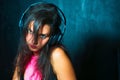 Pretty expressive girl deejay with headphones