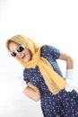 Pretty expressive lady wearing a polka dots dress white sunglasses and yellow scarf in the studio