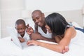 Pretty family using laptop together in bed Royalty Free Stock Photo