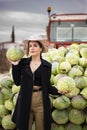 Pretty farm girl with two cabbages in her hands