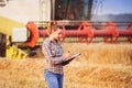 Pretty farmer girl keeps a crop accounting in the folder