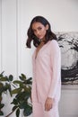 Pretty fashion beautiful woman sexy lady brunette curly hair dark tanned skin wear trend clothes knitted pink pink suit jacket top