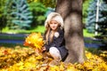 Pretty Fashion girl sitting under a tree with Royalty Free Stock Photo