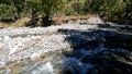 pretty fast mountain stream with clear water at summer day - photo of nature Royalty Free Stock Photo