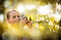 Pretty female amateur photographer taking photos outdoors Royalty Free Stock Photo