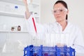 Pretty female biologist holding a manual pipette