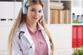 Pretty female blonde doctor talking to patient over wireless headset advises medical problem
