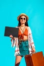 pretty female bohemian traveler with black board and suitcase