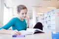 Pretty female college student in a library Royalty Free Stock Photo