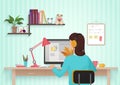 Pretty female designer working with colors at home. Young woman working in office, sitting at desk, using computer Royalty Free Stock Photo